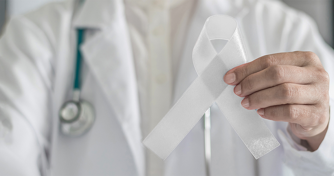 Doctor holding a white ribbon