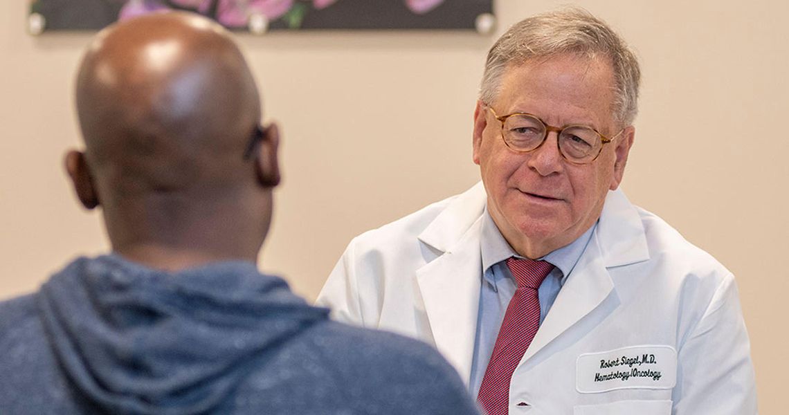 Robert Siegel talking to a patient