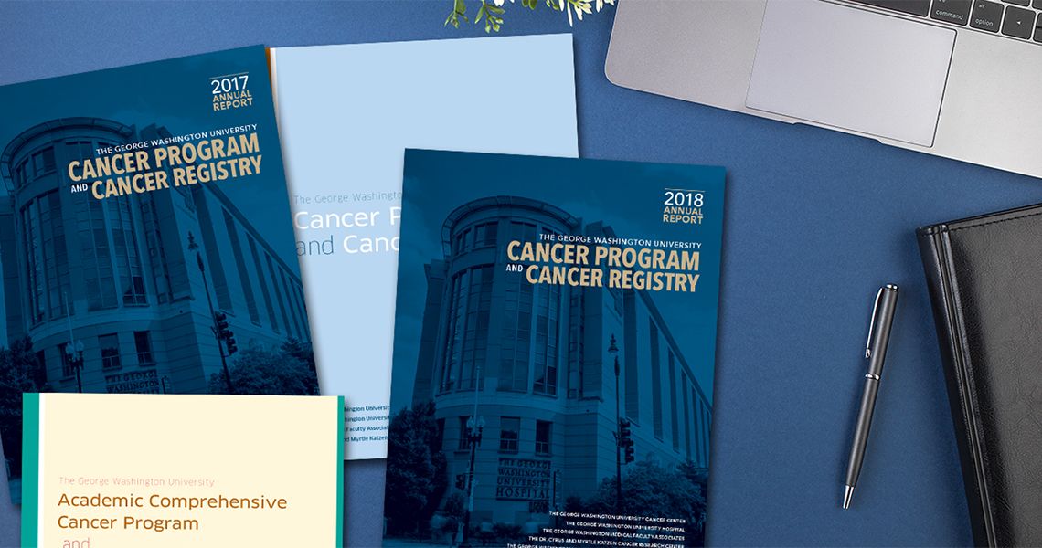 Covers of the Annual Cancer Registry Report on a desk