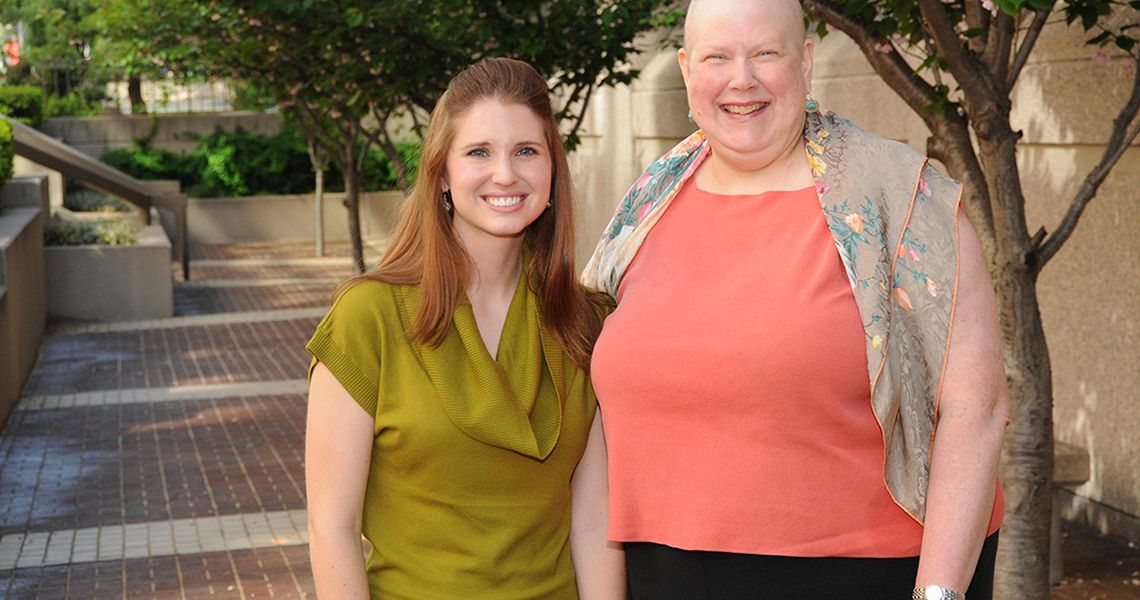 Two women standing next to each other