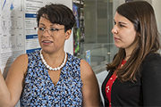 Two researchers looking at a research poster