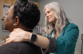 Julie Bauman, MD, examines a patient
